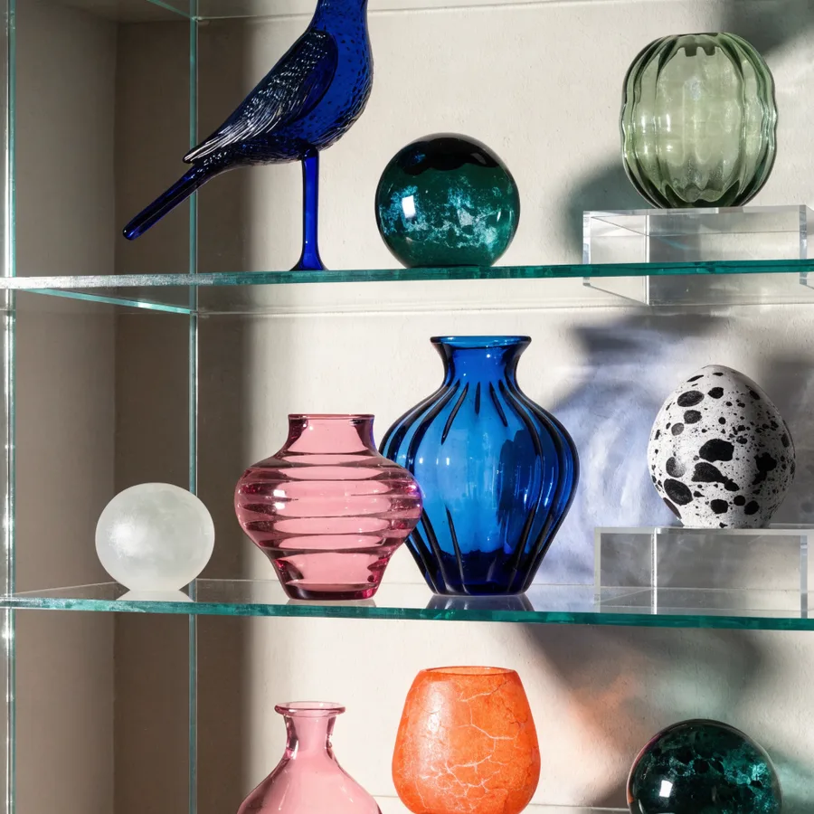 Organized Detolf shelves with tiered acrylic risers for figurines