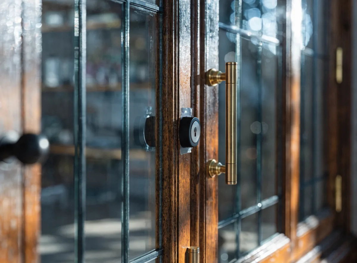 Detolf glass display cabinet with door security and childproof lock context